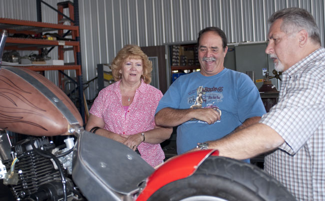 Sandy and Dave Cavanaugh, two of the California Scooter Company's greatest fans, with Steve showing them the LSR bike..don't try asking them questions about this skunk works project...they're sworn to secrecy!