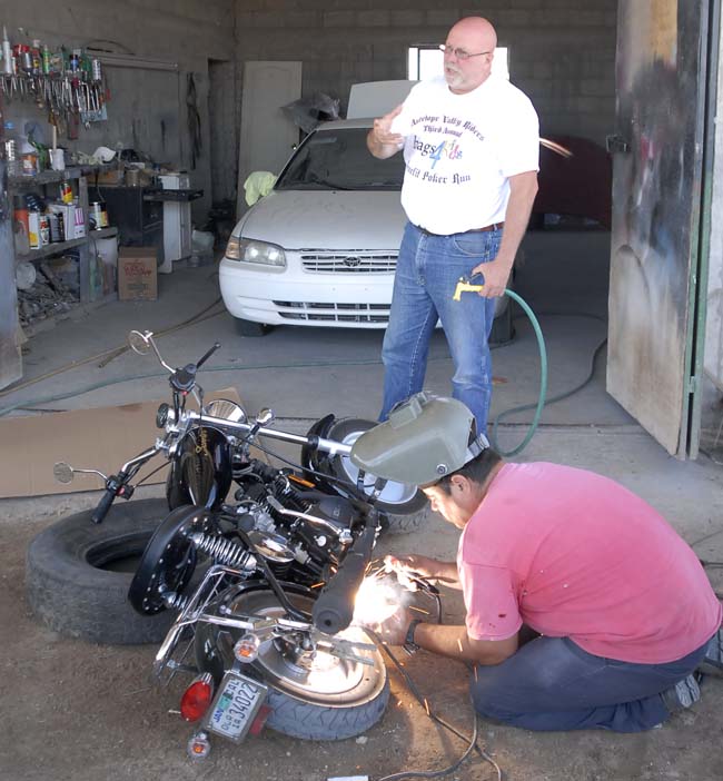 My new friend Umberto modifying John's preproduction bike to the production bike configuration...a mod that worked for the rest of the trip.   Note John standing by to put out any fires.