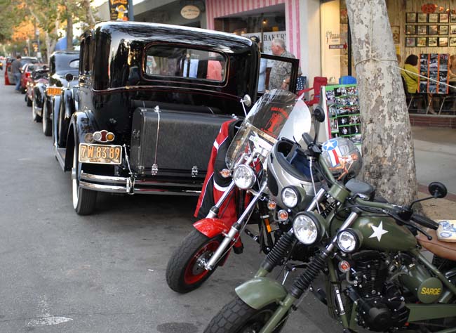 Our California Scooters parked outside the Village Grill, right behind a Packard